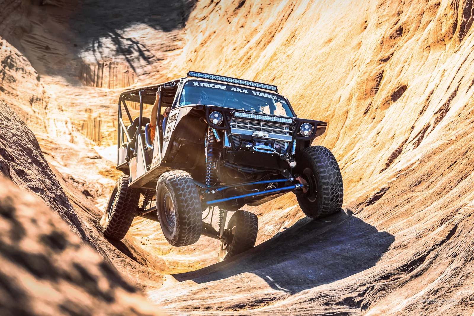 Custom 4x4 climbing between steep sandstone walls