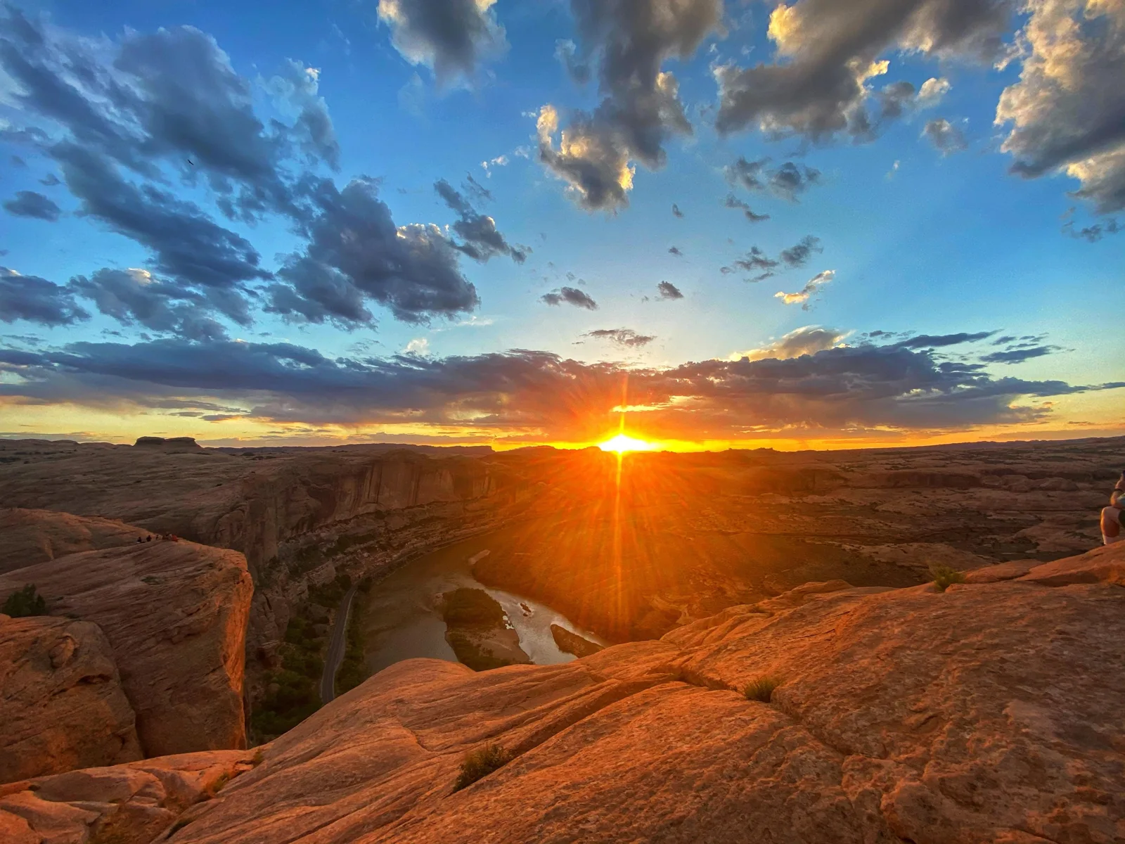 Sun dropping behind the sandstone landscape