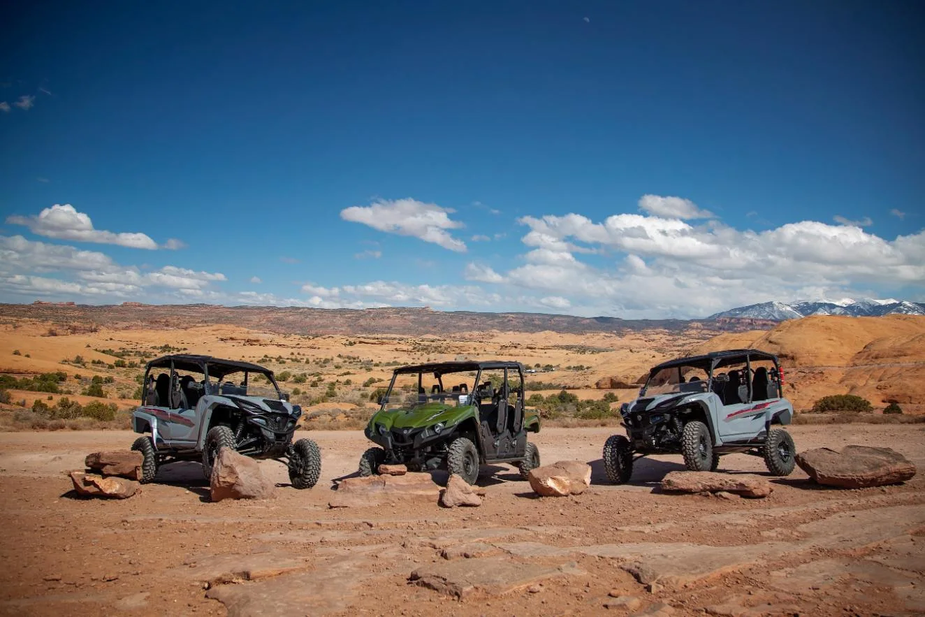 UTVs parked across a sandstone overlook